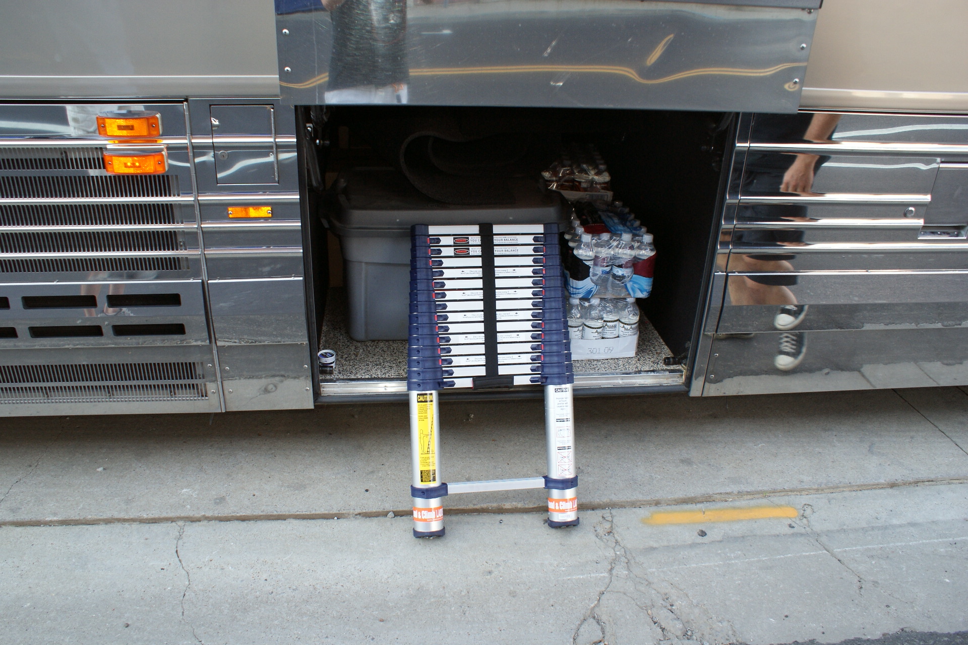 Telescoping ladders easily store in the baggage compartments of this tour bus.