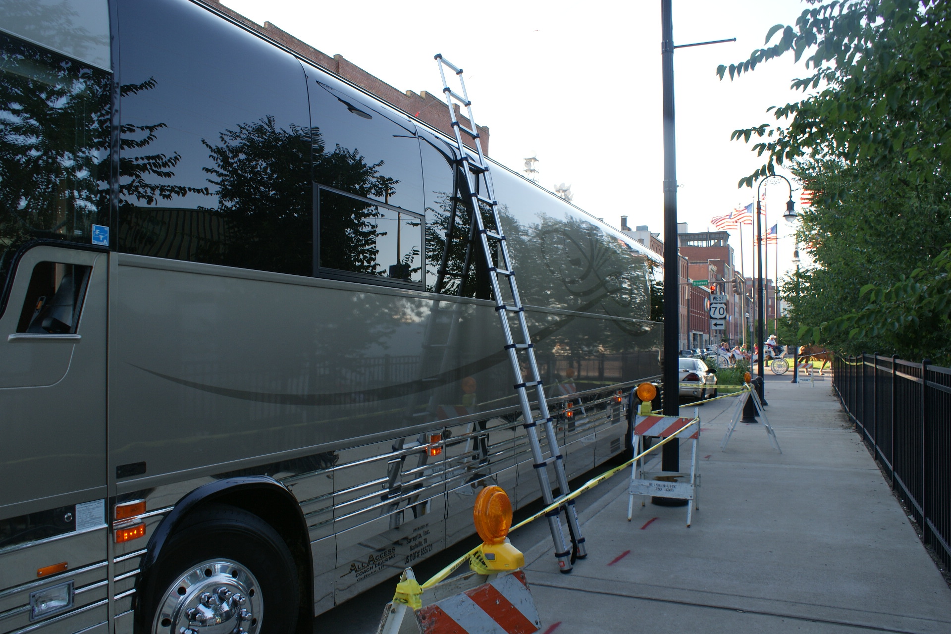 A 785P telescoping ladder being used to access the top of this tour bus.